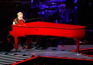 Elton John at a red piano