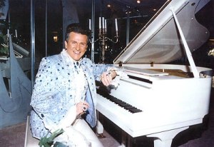 Liberace at a white piano